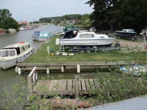 a boat is docked at a dock on a river at Riverside Lodge At Bridge Stores in Great Yarmouth