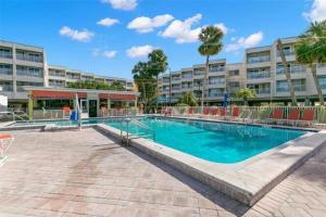 a swimming pool in front of a large building at Beautiful Two Bedroom, Two Bath Condo at Sailport in Tampa