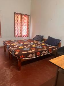 a bed in a room with a blanket on it at Lulu holiday inn in Alleppey