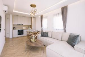 a living room with a white couch and a table at Azanti Residence in Ulcinj