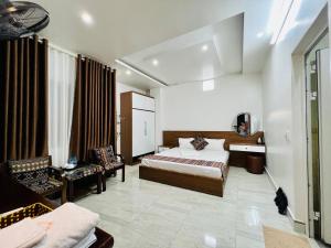a bedroom with a bed and a couch and a chair at Peaceful Mountain Hotel in Ha Giang