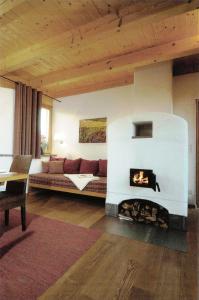 a living room with a couch and a fireplace at Ferienhaus Am Grassnitzberg 18 a in Straß in Steiermark