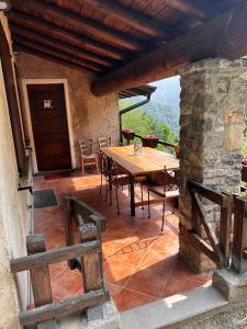 a dining room with a table and a stone wall at Chalet Calcar in Avenone