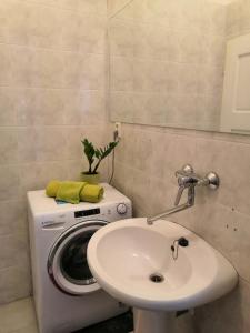 a bathroom with a washing machine and a sink at 3 min Walk Old Town Center private room A in Prague +8 photos