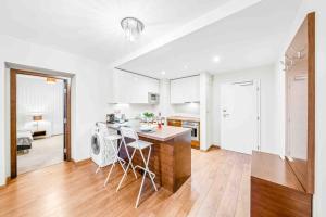 a kitchen and living room with a table and chairs at Parkview apartment 52m2 in Hradiště
