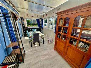 a room with a table and a dining room at La maison bleue in Hermanville-sur-Mer