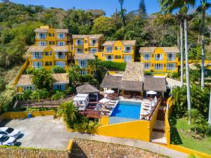 an aerial view of a yellow mansion with a swimming pool at Bahiamarela Boutique Hotel & SPA in Búzios