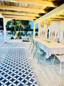 a table and chairs under a pavilion on a patio at Tenuta Victoria in Sava +16 photos