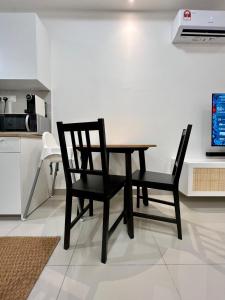 a dining room table and two chairs in a kitchen at Luxury & Comfy studio in the heart of Melaka in Melaka