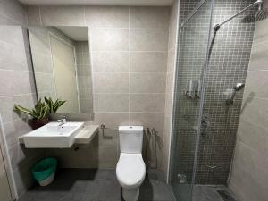 a bathroom with a toilet and a sink and a shower at Luxury & Comfy studio in the heart of Melaka in Melaka +45 photos
