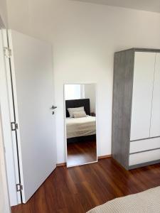 a bedroom with a mirror and a bed at Lena in Jajce