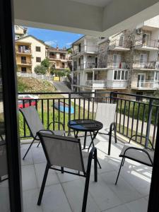 a balcony with a table and chairs and a view at Adria Flow Apartments in Meljine