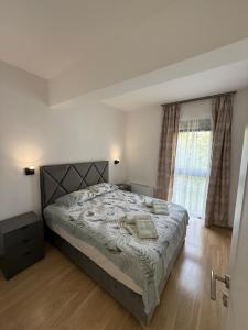 a bedroom with a large bed and a window at Adria Flow Apartments in Meljine