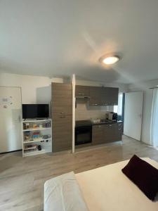 a large room with a kitchen and a bed in it at Super Appartement Pré de Disney. in Chessy