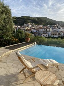 a pair of lounge chairs sitting next to a swimming pool at Aegean Panorama Hideaway & Pool in Samos in Vathý