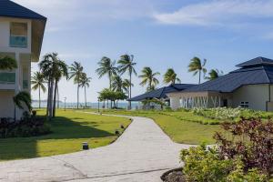 a walkway next to a house and palm trees at Xanadú in Sampiño