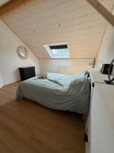 a bedroom with a bed and a window on the ceiling at Gulf Stone in Séné