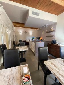 a restaurant with tables and chairs and a kitchen at Modus Vivendi - Room E Relax in Brisighella +17 photos