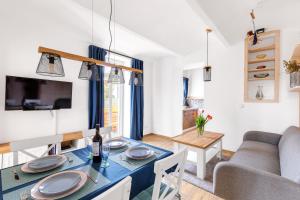a dining room and living room with a table and a couch at Sponge Apartmá - Resort Abertham in Abertamy