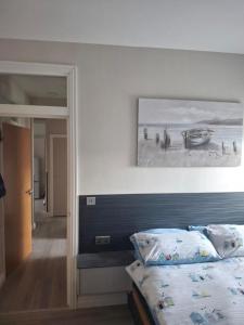 a bedroom with a bed and a painting on the wall at UlsterApartments one bedroom 2 single beds and sofa bed in Portrush