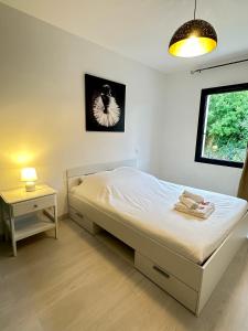 a bedroom with a bed and a table and a window at La Bulle Familiale in Angoulême