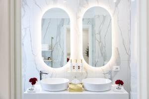 a bathroom with two sinks and two mirrors at Royal House in Santa Maria La Carità +188 photos