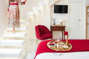 a woman in a dress standing on the stairs in a room at Royal House in Santa Maria La Carità