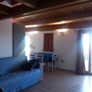 a bedroom with a bed and a table and a dining room at Casa Dora in Porto Pino +9 photos