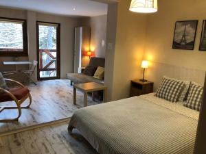 a bedroom with a bed and a living room at Willa Avita in Karpacz