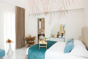 a bedroom with a white bed with a blue blanket at Royal House in Santa Maria La Carità