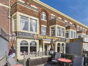 a building with a table and chairs in front of it at Kings Boutique Hotel in Blackpool