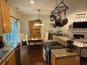 a kitchen with a stove and a kitchen with a table at A House On Catalina in Tigard