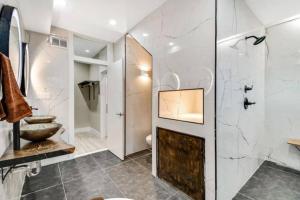 a bathroom with a shower and a sink at Emerald Jacuzzi Loft in Philadelphia +42 photos