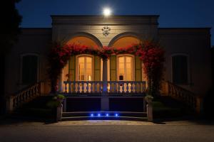 a house with a porch with flowers on it at night at Alchimia SPA & Centro Benessere in Mesagne
