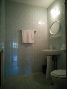 a bathroom with a sink and a toilet and a mirror at Casa de vacanță Tarnița in Someşu Cald +15 photos