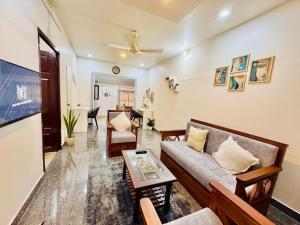a living room with a couch and a table at Grandpa's Home in Alleppey