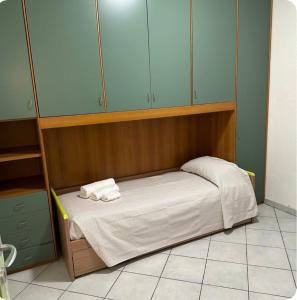 a small bed in a room with blue cabinets at Casa Calaverde in Fort Village
