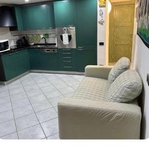 a living room with green cabinets and a couch at Casa Calaverde in Fort Village