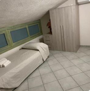 a bedroom with a bed and a tiled floor at Casa Calaverde in Fort Village +1 photo