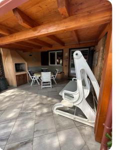 a patio with a table and chairs under a wooden ceiling at Casa Calaverde in Fort Village