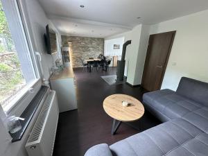 a living room with a couch and a table at Ferienhaus EifelJECK in Blankenheim
