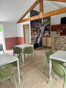 a room with tables and chairs and a waterfall mural at Casinhas do Marão in Parada +29 photos