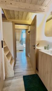 a bathroom with a staircase leading to a bedroom at La Tana del Cervo del Maso K in Folgaria +37 photos