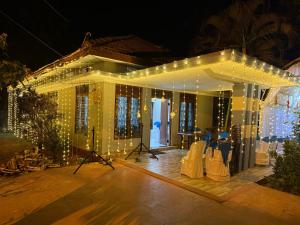 a house with christmas lights on the front of it at Yarl Nest in Jaffna +10 photos