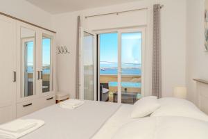Postel nebo postele na pokoji v ubytování Apartment by the sea and with beautiful view, 2 bedrooms, 4 persons