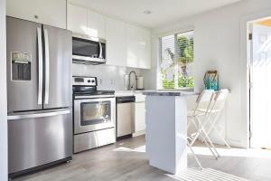 a kitchen with white cabinets and stainless steel appliances at Waterfront Cabana 6 Key Largo in Key Largo