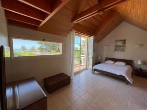 a bedroom with a bed and a large window at Villa en bord de mer 6 personnes, à côte du Château des Tourelles, piscine d'eau de mer in Pornichet +30 photos