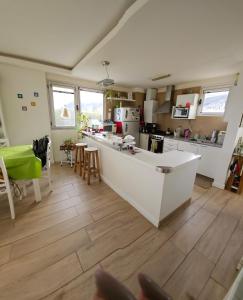 a kitchen with a white counter top in a room at Dreamy views in Ushuaia +12 photos