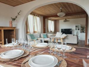 a table with plates and wine glasses on it at Chalet Toscane avec bain nordique in La Bresse