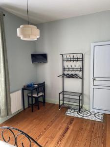 a room with a table and a chair and a shelf at Mignères in Auxy